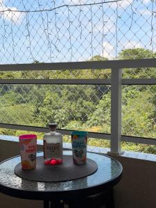 a table with a bottle of milk and two cups at Ponta Negra Apartment in Manaus