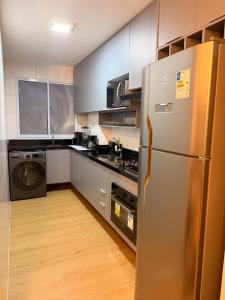 a kitchen with a stainless steel refrigerator at Ponta Negra Apartment in Manaus