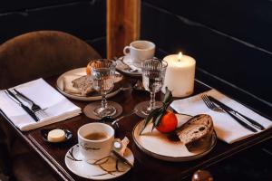 a table with plates of food and a candle at Demeure Sauvage - Étage 2 in Villard-Reculas +4 photos