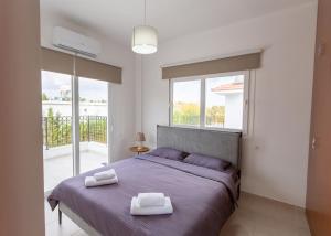 a bedroom with a bed with two towels on it at Crystal Villa walk by Merit Casinos By HolidayKeys in Kyrenia