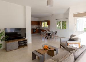 a living room with a couch and a table at Crystal Villa walk by Merit Casinos By HolidayKeys in Kyrenia