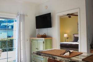 a room with a table with a dog on a counter at The Jr. Suite at 205 Royal Poste Rd. in Sunset Beach