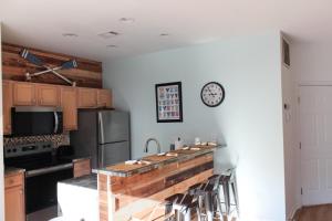 a kitchen with a counter and a clock on the wall at The Jr. Suite at 205 Royal Poste Rd. in Sunset Beach