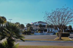 a tree in a parking lot in front of a building at The Jr. Suite at 205 Royal Poste Rd. in Sunset Beach
