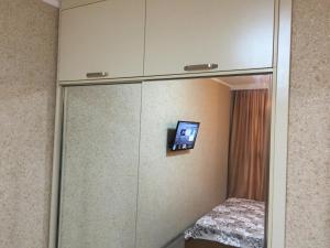 a small tv on a wall in a room at Sea Towers 2 room apartment in Batumi