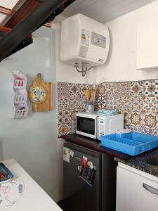 a kitchen with a microwave on top of a counter at Tu casa en Montevideo in Montevideo +36 photos