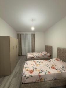 a room with two beds in a room at Modern 2-Bed Near Tirana and Airport with Balconies in Kamëz