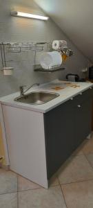 a kitchen counter with a sink in a room at Colle dell'Ara in Chieti +32 photos
