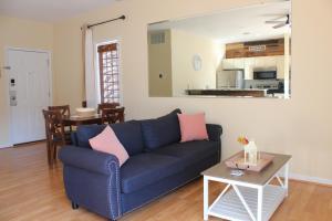 a living room with a blue couch and a table at Royal Villa in Sunset Beach
