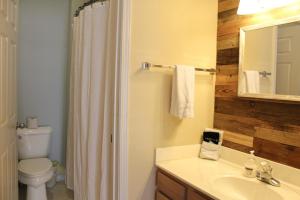 a bathroom with a sink and a toilet and a mirror at Royal Villa in Sunset Beach +22 photos