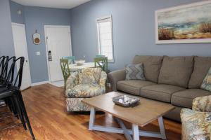a living room with a couch and a table at The Villa at 125 Royal Poste Rd in Sunset Beach