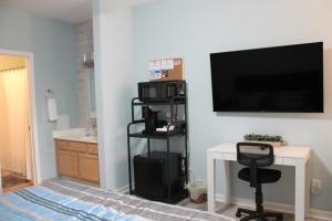 a living room with a flat screen tv on a wall at Beach Bungalow by Coastal Concierge in Sunset Beach