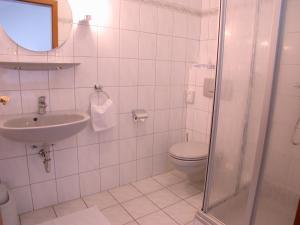 Un baño blanco con inodoro y lavabo. en Hotel Goos, en Jübek 10 fotos más