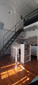 a white table in a room with a staircase at Tu casa en Montevideo in Montevideo