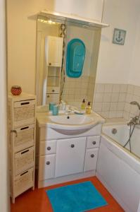 een badkamer met een wastafel, een spiegel en een bad bij Les Cerfs Volants 2 à 4 pers in Dieppe +43 foto's
