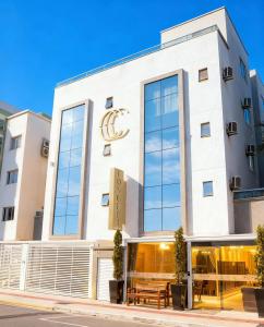 a large white building with a sign on the front at Concept Hotel Flat in Balneário Camboriú