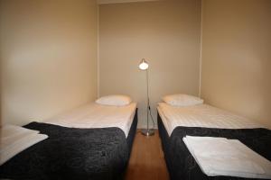Кровать или кровати в номере Hotel Aakenus Apartment Koski