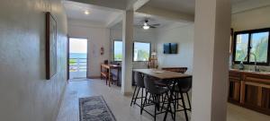 a kitchen and dining room with a table and chairs at Lickety Split-Oceanview with Rooftop Escape in Caye Caulker