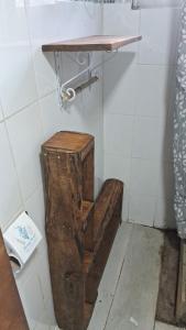 a wooden toilet in a bathroom with a shelf at Cabaña con tinaja para 6 personas in San Clemente