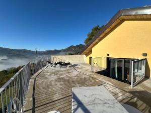 a wooden deck with a bench on top of a building at Ca Jurzot in Gorzegno