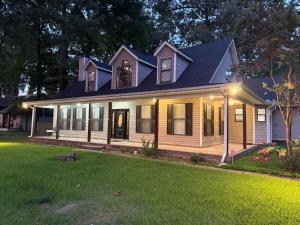 a white house with a blue roof and a yard at Marion Getaway in Marion