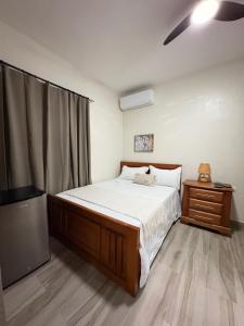 a bedroom with a bed and a flat screen tv at Doña Dinde Vacacional in Punta Cana +14 photos