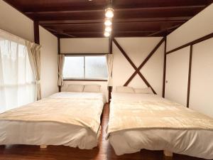 Ένα ή περισσότερα κρεβάτια σε δωμάτιο στο まるとくハウス霧島