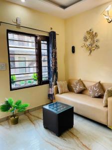 a living room with a couch and a window at The Healing Haven in Kharar