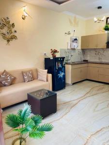 a living room with a couch and a kitchen at The Healing Haven in Kharar