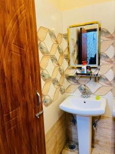 a bathroom with a sink and a mirror at The Healing Haven in Kharar