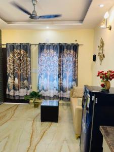 a living room with a couch and a window with trees at The Healing Haven in Kharar