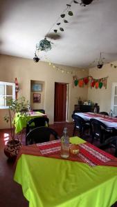 a dining room with tables and green table cloth at Hospedaje La Casona de los Paredones in Charbonier +38 photos