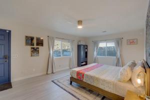 a bedroom with a bed and a large window at The Maharaja Retreat with Hot Tub and EV Charger! in Yucca Valley