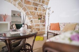 un soggiorno con un tavolo e un divano di Sweet Home Arco Porta Luce a Galatina