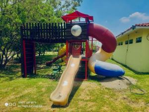 a playground with a slide and a play structure at Casa en Cuautla, Morelos 