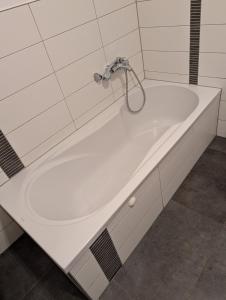 a bath tub with a faucet in a bathroom at Large city apartment with beautiful views in Marburg an der Lahn