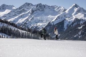 two people skiing on a snow covered mountain at Mount Apart in Zell am Ziller