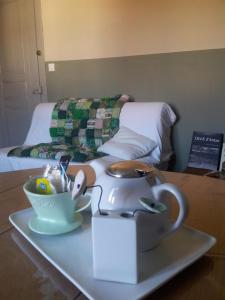 a tea kettle on a tray on a table next to a bed at Wazemoff in Lille