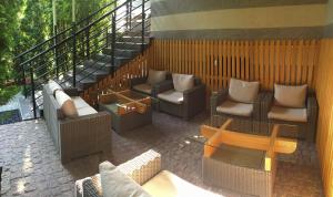 a patio with couches and chairs and a table at Komilfo Hotel in Chişinău