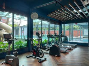 a gym with several treadmills and elliptical machines at Jhomestay2 in Sandakan
