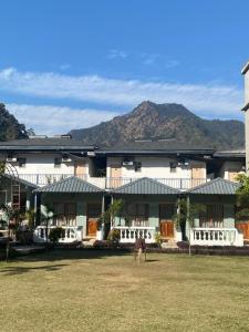 a building with a horse standing in front of it at Glampers Resort Rishikesh at River Side in Rishīkesh