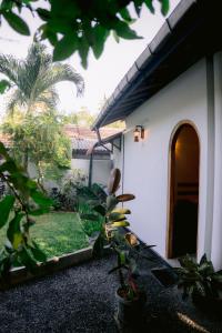 a house with a courtyard with plants in front of it at Ninety Four Plus Madiha in Matara +23 photos