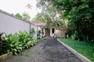 a walkway leading to a house with a yard at Ninety Four Plus Madiha in Matara