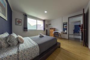 a bedroom with a bed and a window and a table at Casa Hidalgo By Mi Querido Coyoacán in Mexico City +111 photos