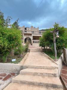 a building with stairs leading up to a building at Auberge jawahir aguerd 