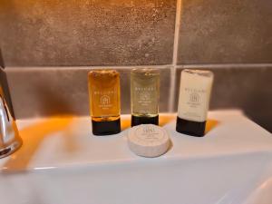 two bottles of soap sitting on top of a sink at Loft Airport Hotel in Arnavutköy