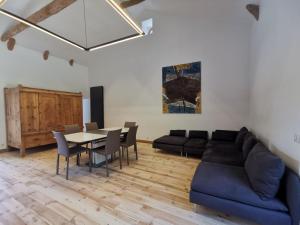 a living room with a couch and a table at La FRAMBOISINE in Les Granges