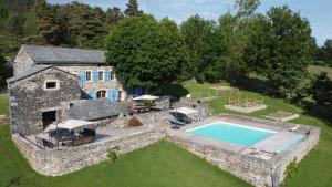 an aerial view of a stone house with a swimming pool at La FRAMBOISINE in Les Granges