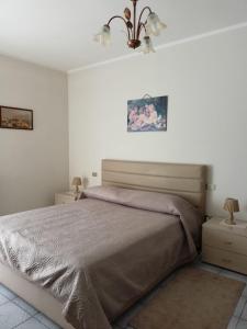a bedroom with a large bed and two night stands at Casa Canale in Gesualdo