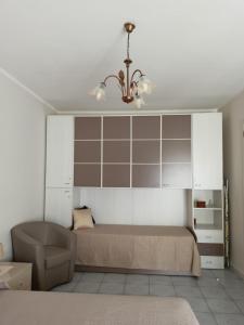 a bedroom with a bed and a chandelier at Casa Canale in Gesualdo